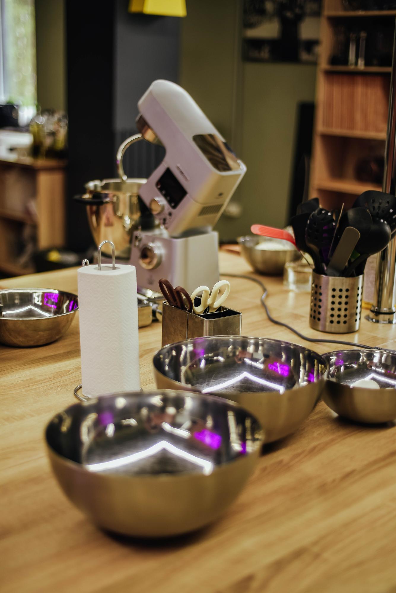 Studio kitchen with stainless tools and neon accents